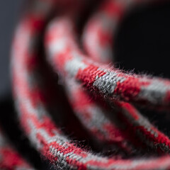 Red and Grey Braided Cable on Black Background