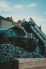 Vertical shot of the coal being loaded up into a Steam Train in Paignton, Devon UK