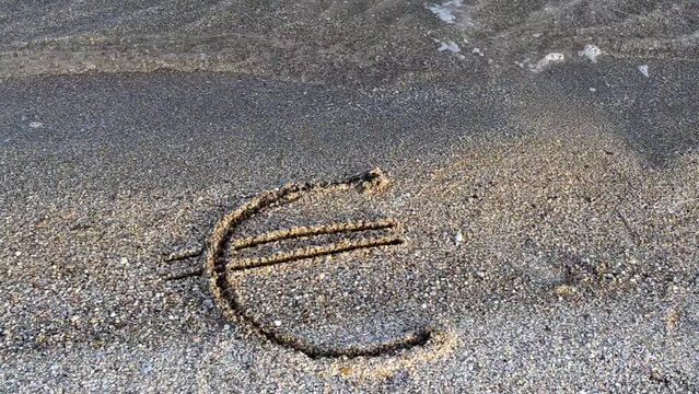 Euro sign on sand. Sand and currency.