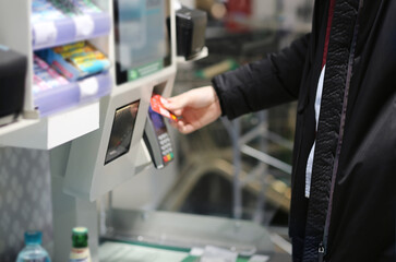 Customer pays his purchase at the supermarket,self checkout systems in  retail stores,Barcode scanner,Self checkout machine