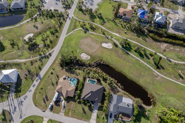 Hurricane Ian destroyed homes in Florida residential area on golf course. Natural disaster and its consequences