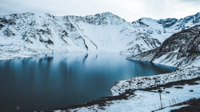 Scenic View Of Snowcapped Mountains Against Lake. Landscape In South America.