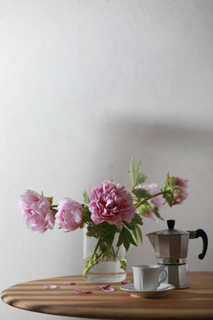 Cup Of Coffee, Geyser Coffee Maker And Bunch Of Peony Flowers On Wooden Table. Copy Space