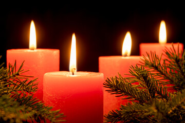Four red candles with Christmas decoration background