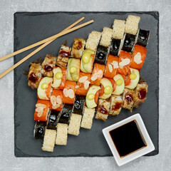 beautifully laid out sushi set on a blackboard