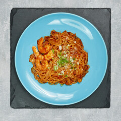 pasta in a blue plate on a gray background