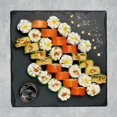 beautifully laid out sushi set on a blackboard