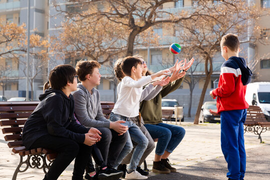 Kids playing ball together on the street. High quality photo