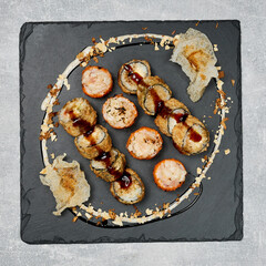 beautifully laid out sushi set on a blackboard