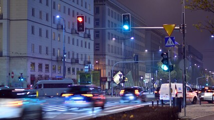 Evening city life in the centre. Cars on street. City street lights at night.