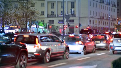 Naklejka premium Evening city life in the centre. Cars on street. City street lights at night.