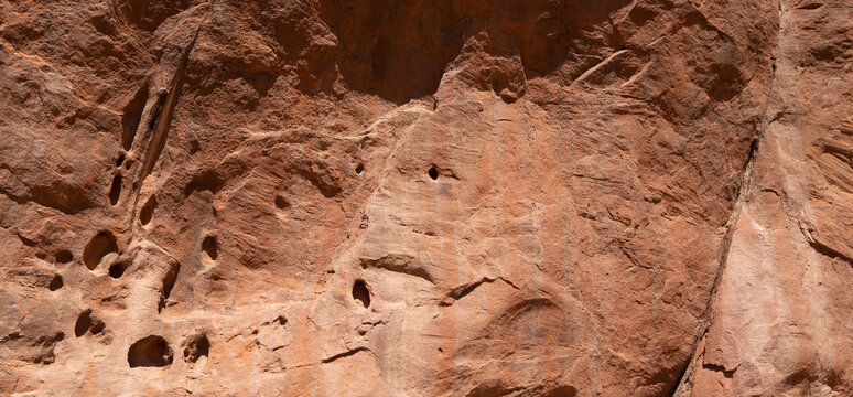 Red rock wall surface background. Abstract sandstone texture banner.