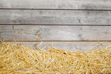Natural background of wooden boards with rural straw and copy space.