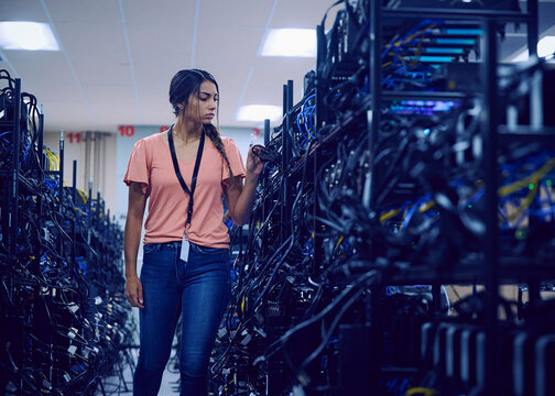 Female technician working in server room