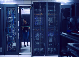 Female technician carrying hard drive in server room