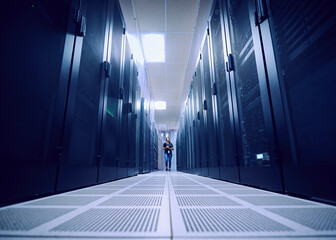 Female technician working in server room