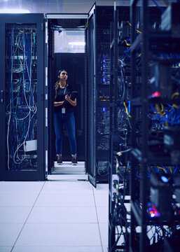 Female technician working in server room