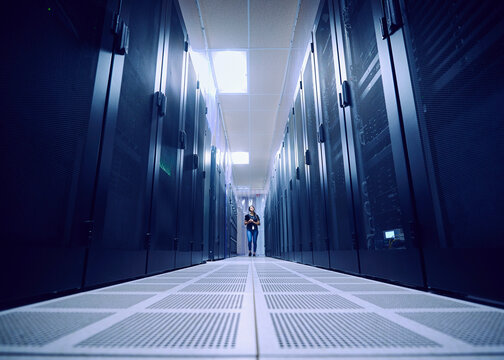 Female technician working in server room