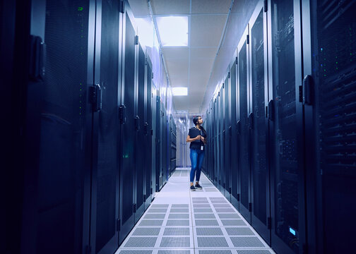 Female technician working in server room