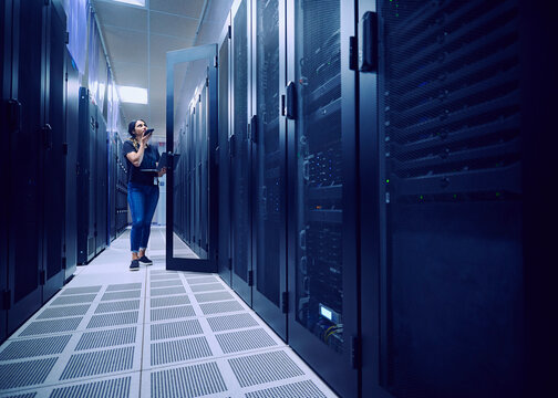 Female technician working in server room