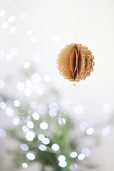 Handmade paper Christmas ball isolated on festive background with copyspace eco living concept made of recycled paper