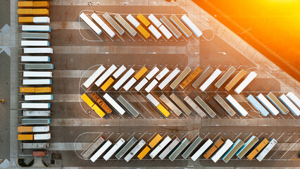 Obraz premium Aerial view of large warehouses of goods, a logistics center and many parked containers and trailers with cargo, logistics warehouses in the industrial areas of the city