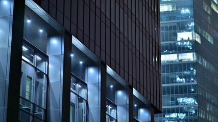 Modern office building in city at the night. View on illuminated offices of a corporate building....