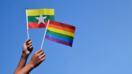 Rainbow flag and National flags of Myanmar, soft and selective focus, concept for LGBT celebration and respecting gender diversity of human in Myanmar and around the world.