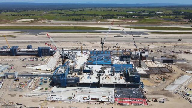 Aerial drone pullback reverse view of the construction site of the new Western Sydney International Airport at Badgerys Creek in Western Sydney, NSW, Australia looking from the east in November 2022 
