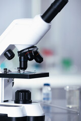 Modern medical microscope with glass slide in laboratory, closeup
