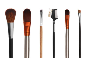 Set with different makeup brushes for applying cosmetic products on white background