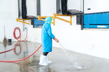 Worker use high pressure water spray cleaning floor