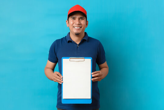 Young Asian delivery man holding empty clipboard for copy space