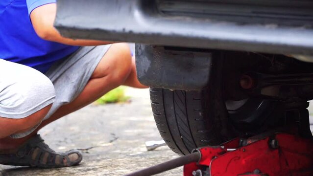 Man is changing fit car tires, slow motion shot. automotive stock videos.