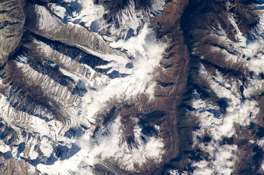 Aerial view of Bhutan shows the Himalayan peaks, lakes, and glaciers from above. Digitally enhanced. Image courtesy of the Earth Science and Remote Sensing Unit, NASA Johnson Space Center.