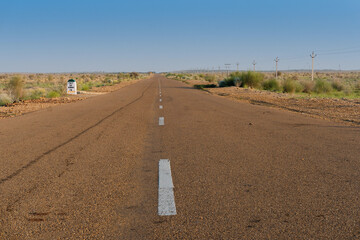 Morning in desert with empty high road or national high way passing through the desert. Distant...