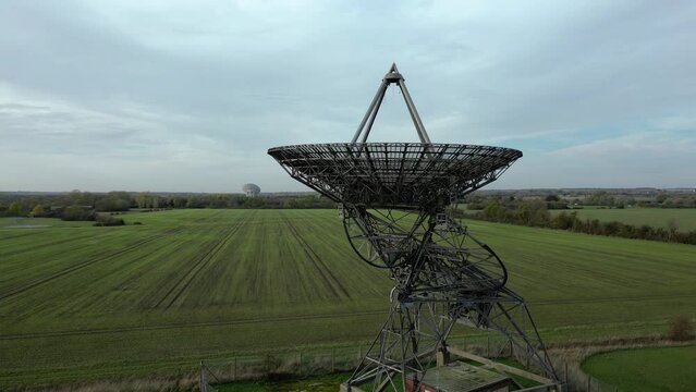 Aerial ascending orbit shot of the radiotelescope antenna at MRAO, Cambridge, UK
