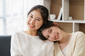 Happy LGBTQ Asian Lesbian Couple Two Asian girls show their love by cuddling and having romance together at home. Positive emotions and LGBT lesbian moments.