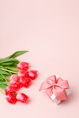 Gift or present box and tulips on pink table top view. Flat lay composition for birthday, mother day, saint Valentine day, wedding. Flyer, invitation, banner for your site, greeting card with  - 548643564