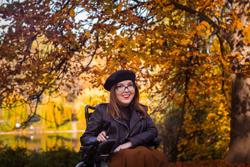 Fototapeta na wymiar woman in a wheelchair in autumn nature.