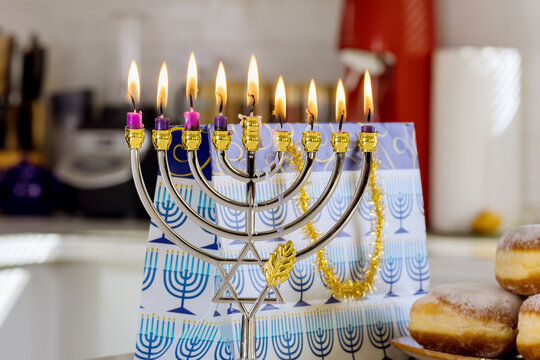 Hanukkah celebration Judaism tradition holiday symbols lighting hanukkiah menorah candles