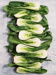 Vertical shot of Bok choy on a white grungy background