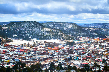 aerial view of a town in winter with snow in the mountains, creel chihuahua 