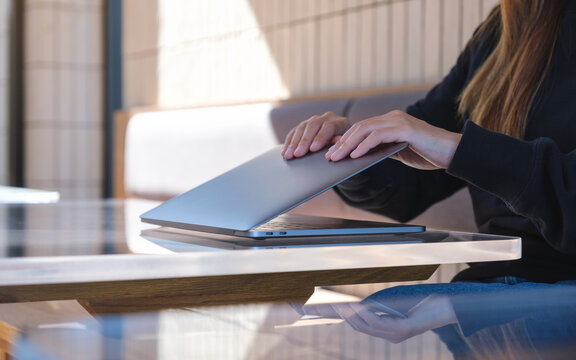 Closeup Image Of Hands Close And Open A Laptop Computer On Table After Finished Using It