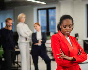 Young african woman is upset because of the ridicule of colleagues. Racial discrimination in the...