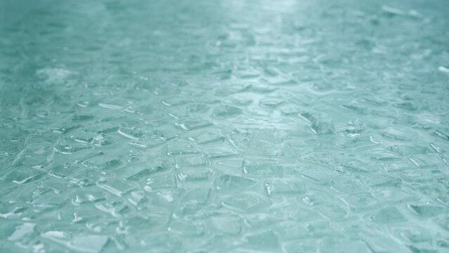 Ice Cubes Floating On The Water In The Tub For Ice Bath - Wim Hof Cold Therapy Method. - close up