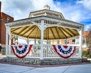Low angle shot of a gazebo with a cloudy blue sky background
