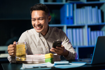 Overtime work concept, Handsome asian business man working late at night in office workplace.