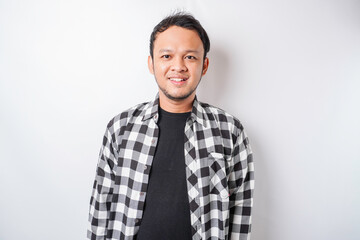 A portrait of a happy Asian man wearing tartan shirt is smiling isolated by white background