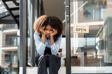 black woman waiter of street cafe is waiting for clients, customersm she is bored, no people in...